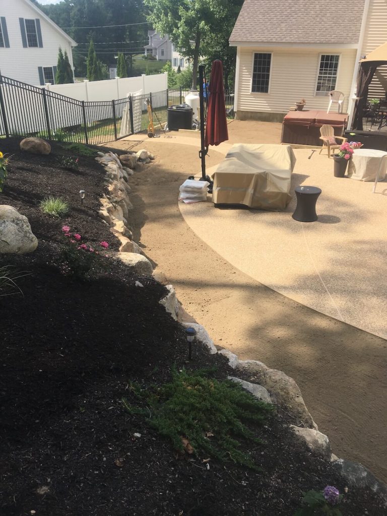 Loam grading around pool, rock wall